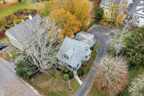 an aerial view of a house with a yard