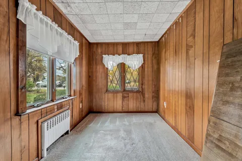 a view of a room with wooden floor and windows