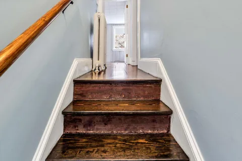 a view of an entryway with wooden floor