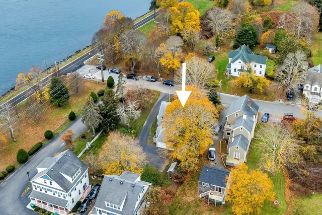 an aerial view of a house with a yard