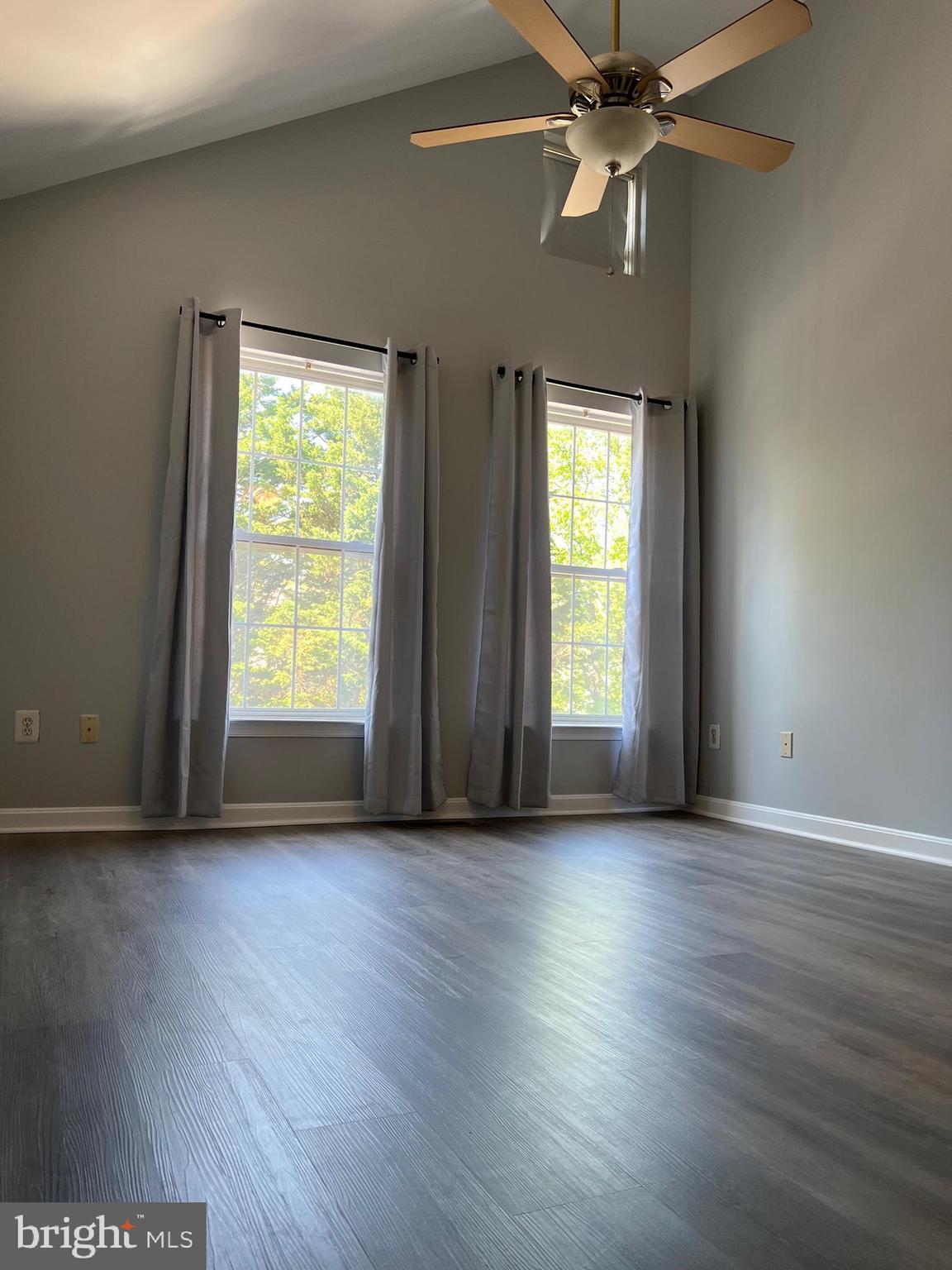 13001 Bridger Drive, Unit 1514 Germantown, MD 20874 - Photo 11 of 15 an empty room with wooden floor fan and windows