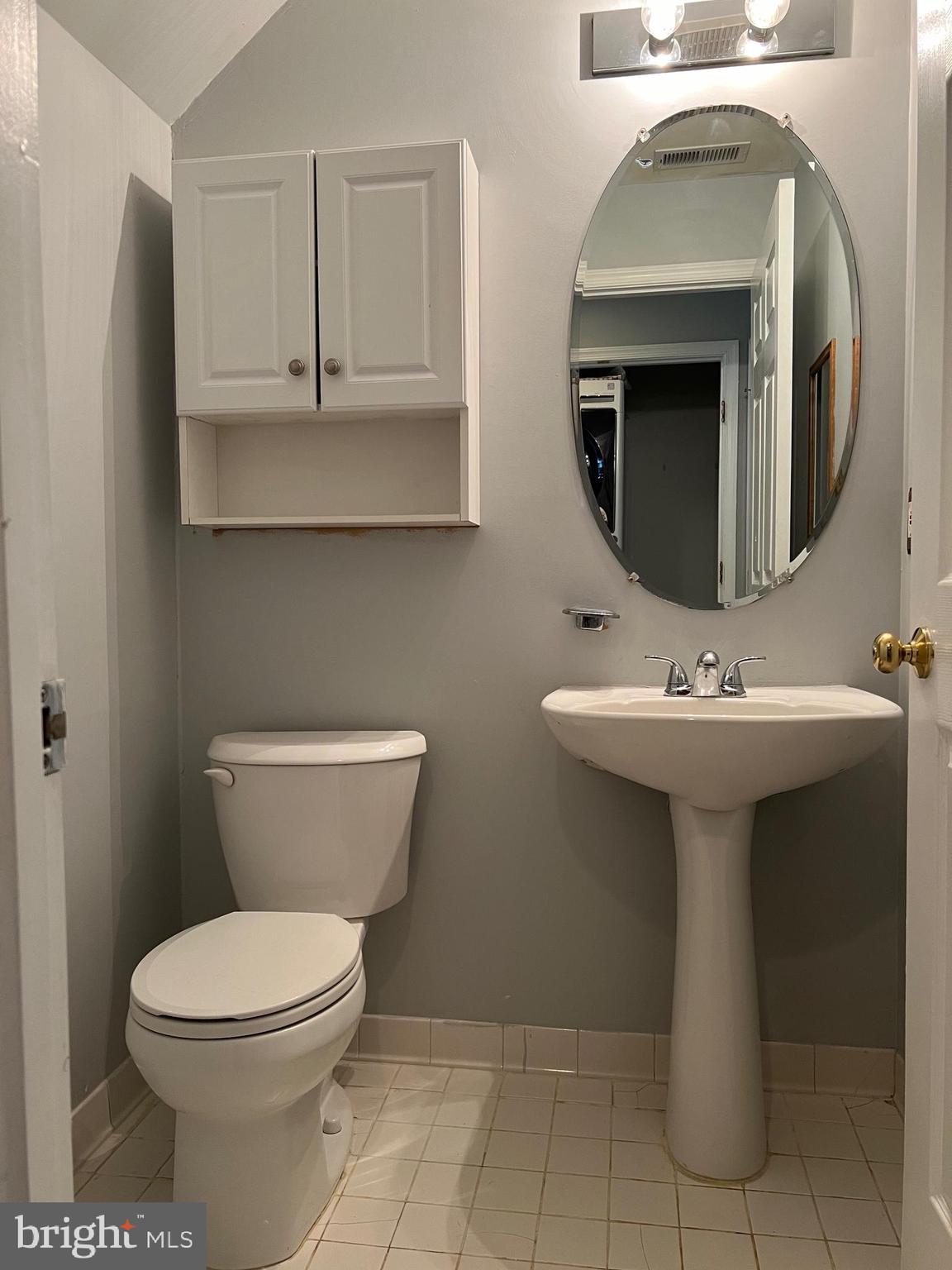 13001 Bridger Drive, Unit 1514 Germantown, MD 20874 - Photo 7 of 15 a bathroom with a toilet sink and mirror