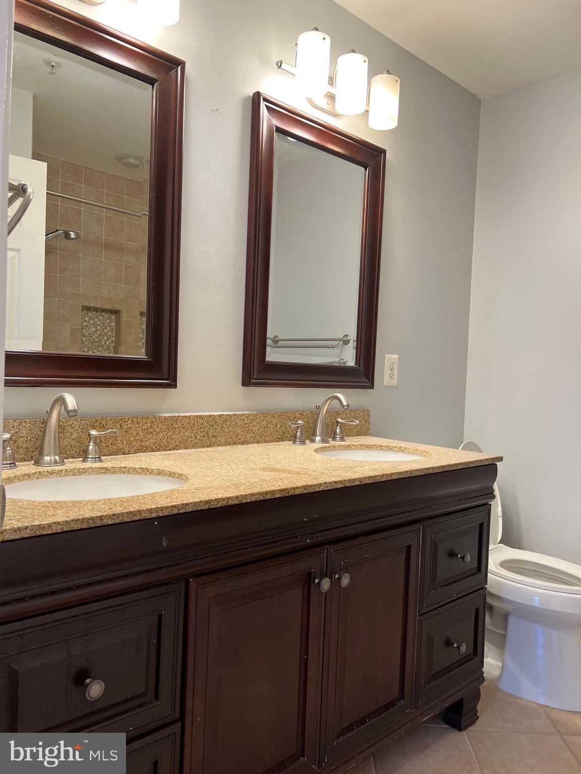 13001 Bridger Drive, Unit 1514 Germantown, MD 20874 - Photo 10 of 15 a bathroom with a double vanity sink and a mirror