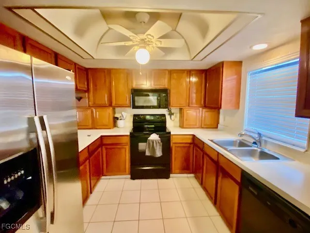a kitchen with stainless steel appliances granite countertop a sink a stove and a refrigerator