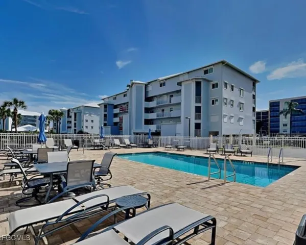 a view of a swimming pool with chairs