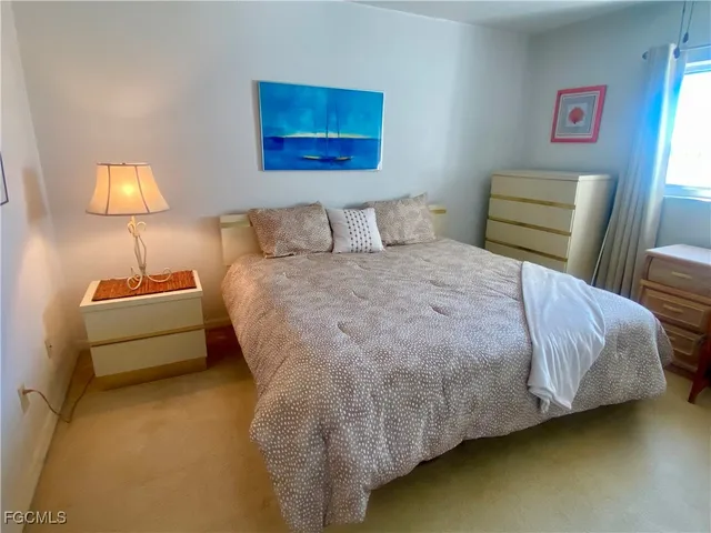 a bedroom with a bed and a lamp