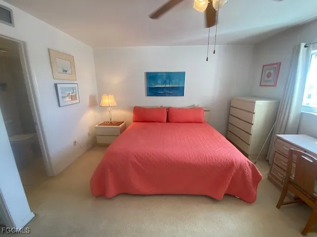a bedroom with a bed and a lamp