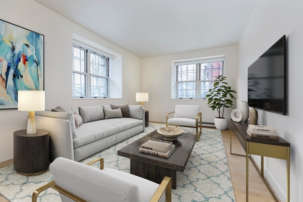 30 Monument Square, Unit 107 Boston, MA 02129 - Photo 2 of 11 a living room with furniture a flat screen tv and a window