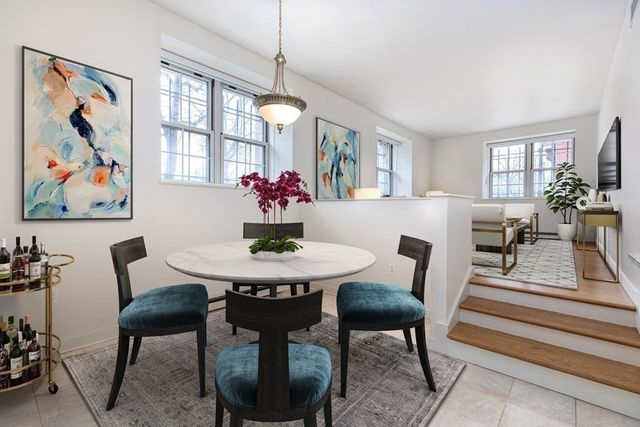 a view of a dining room with furniture and a potted plant