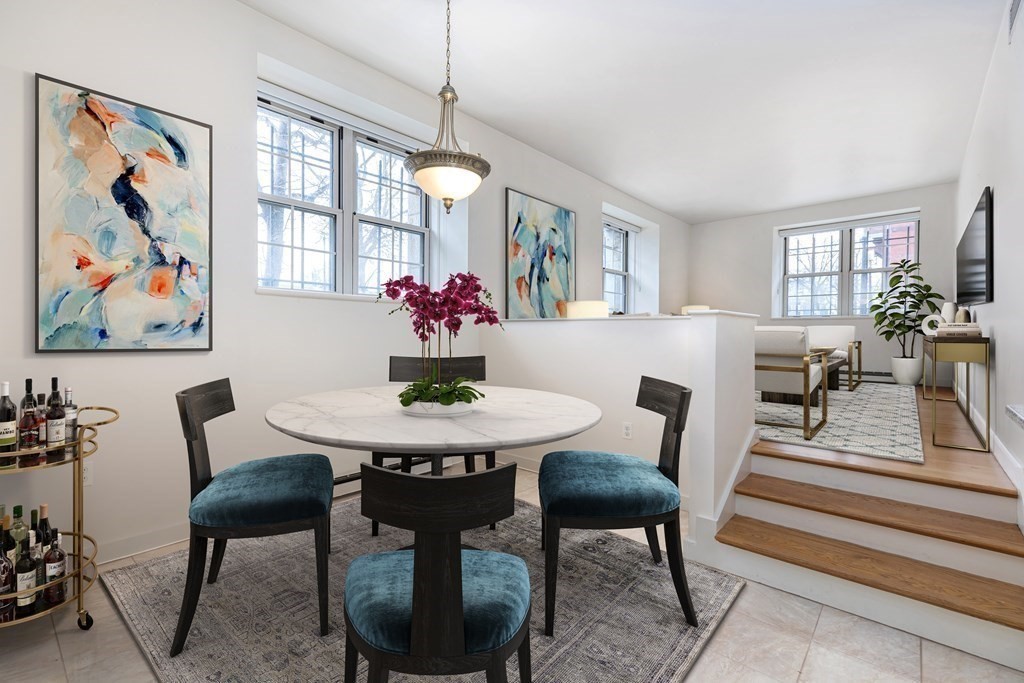 30 Monument Square, Unit 107 Boston, MA 02129 - Photo 3 of 11 a view of a dining room with furniture and a potted plant