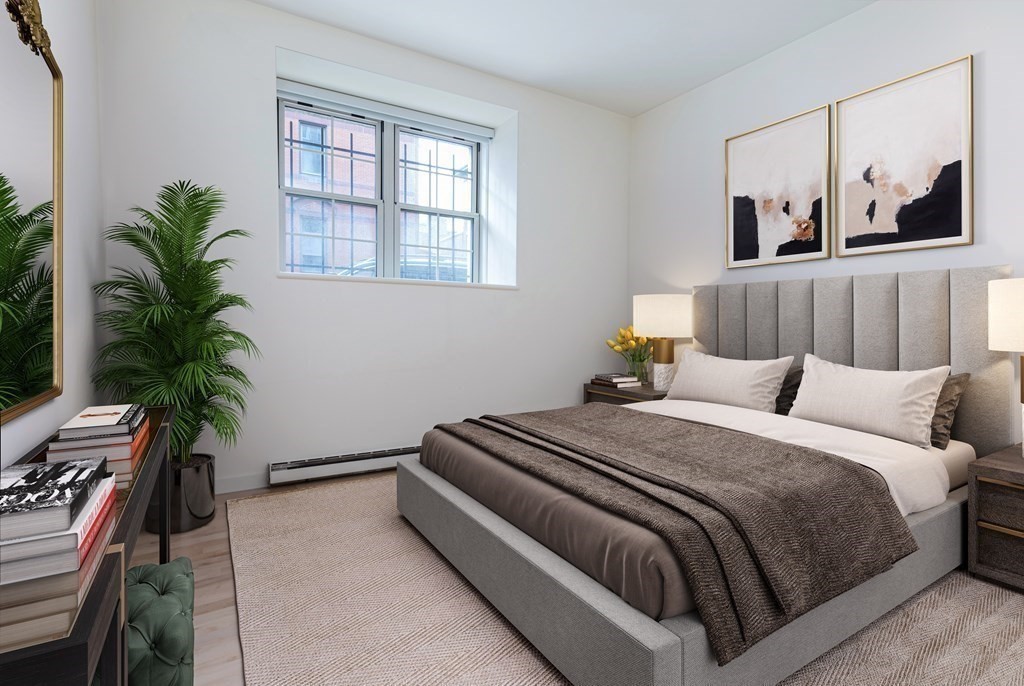 30 Monument Square, Unit 107 Boston, MA 02129 - Photo 5 of 11 a bedroom with a bed and a potted plant