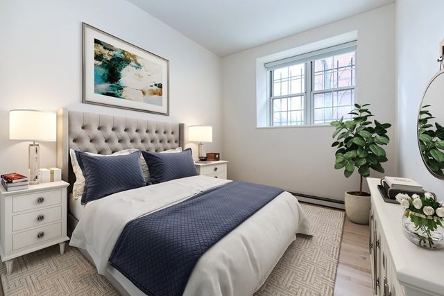 a bedroom with bed and a potted plant