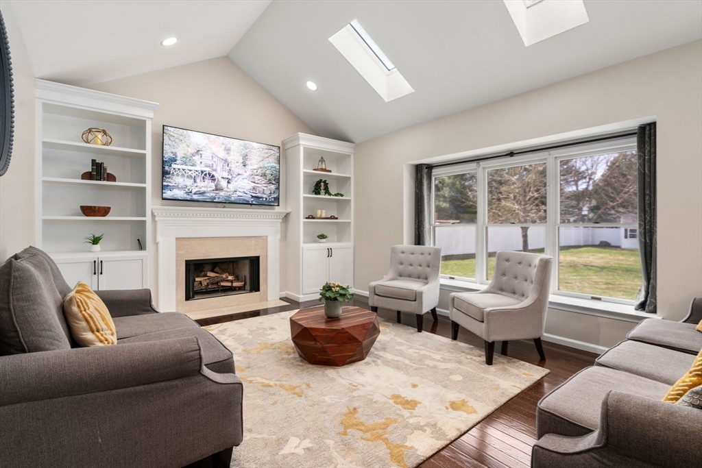 11 Iron Hollow Road Sharon, MA 02067 - Photo 11 of 42 a living room with furniture a large window and a fireplace