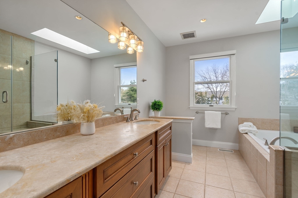 11 Iron Hollow Road Sharon, MA 02067 - Photo 20 of 42 a spacious bathroom with a granite countertop sink a toilet mirror and a bathtub