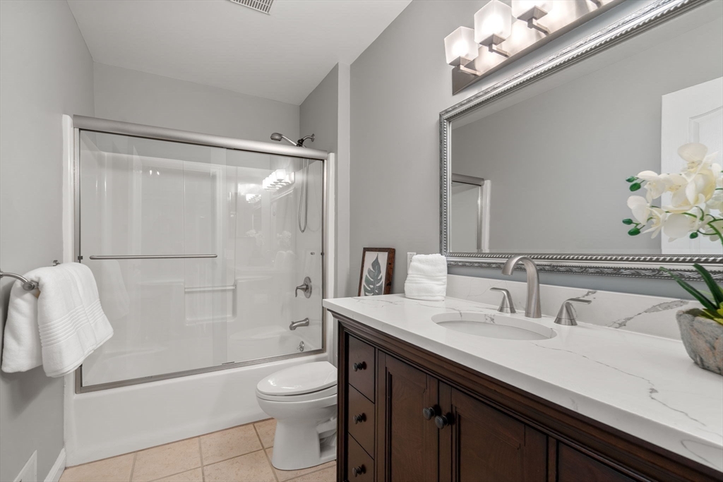 11 Iron Hollow Road Sharon, MA 02067 - Photo 26 of 42 a bathroom with a granite countertop sink a toilet a shower and a mirror