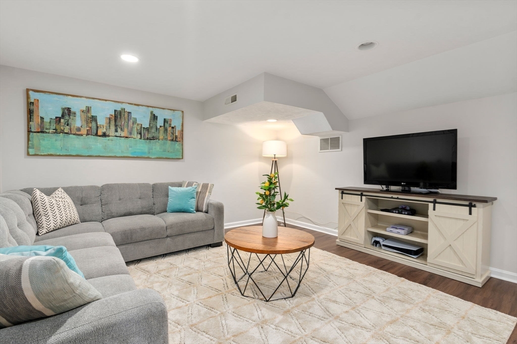 11 Iron Hollow Road Sharon, MA 02067 - Photo 28 of 42 a living room with furniture and a flat screen tv