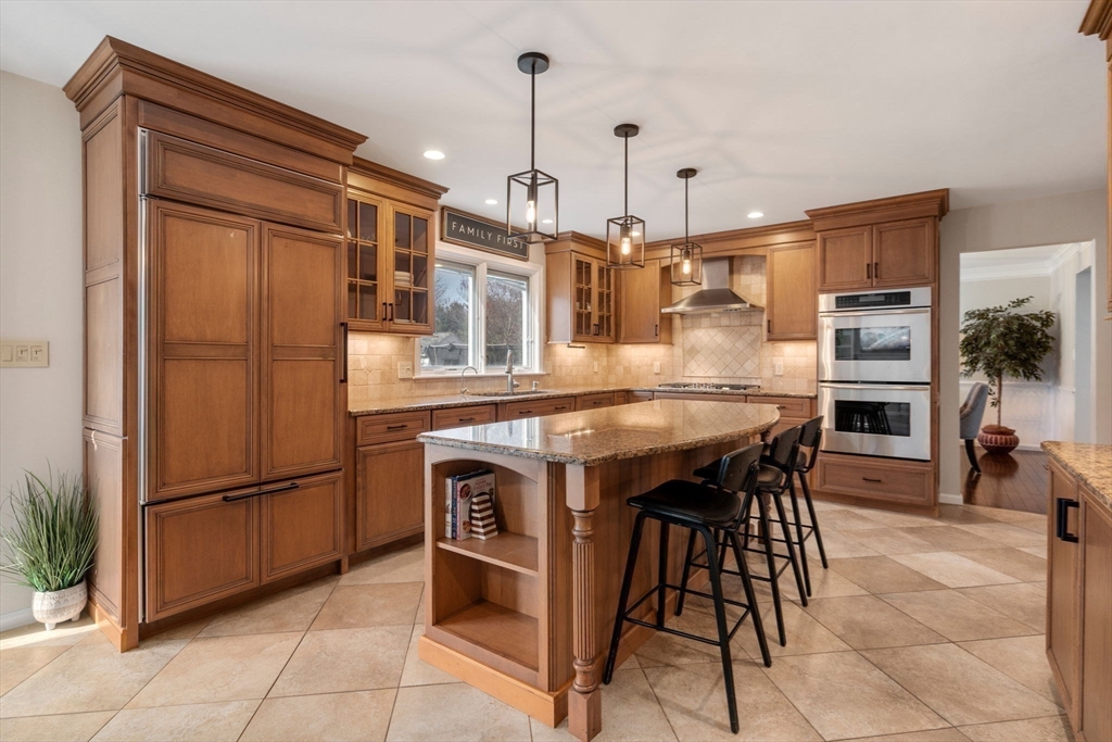 11 Iron Hollow Road Sharon, MA 02067 - Photo 6 of 42 a kitchen with stainless steel appliances granite countertop a table chairs and a refrigerator