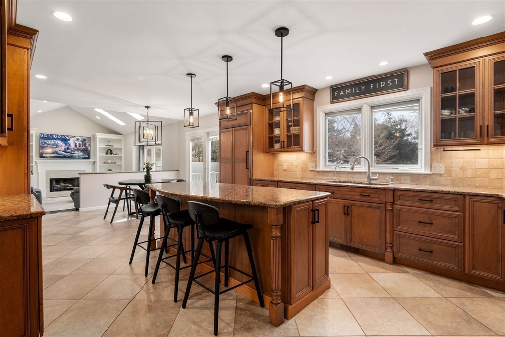 11 Iron Hollow Road Sharon, MA 02067 - Photo 8 of 42 a kitchen with stainless steel appliances granite countertop wooden cabinets a dining table and chairs