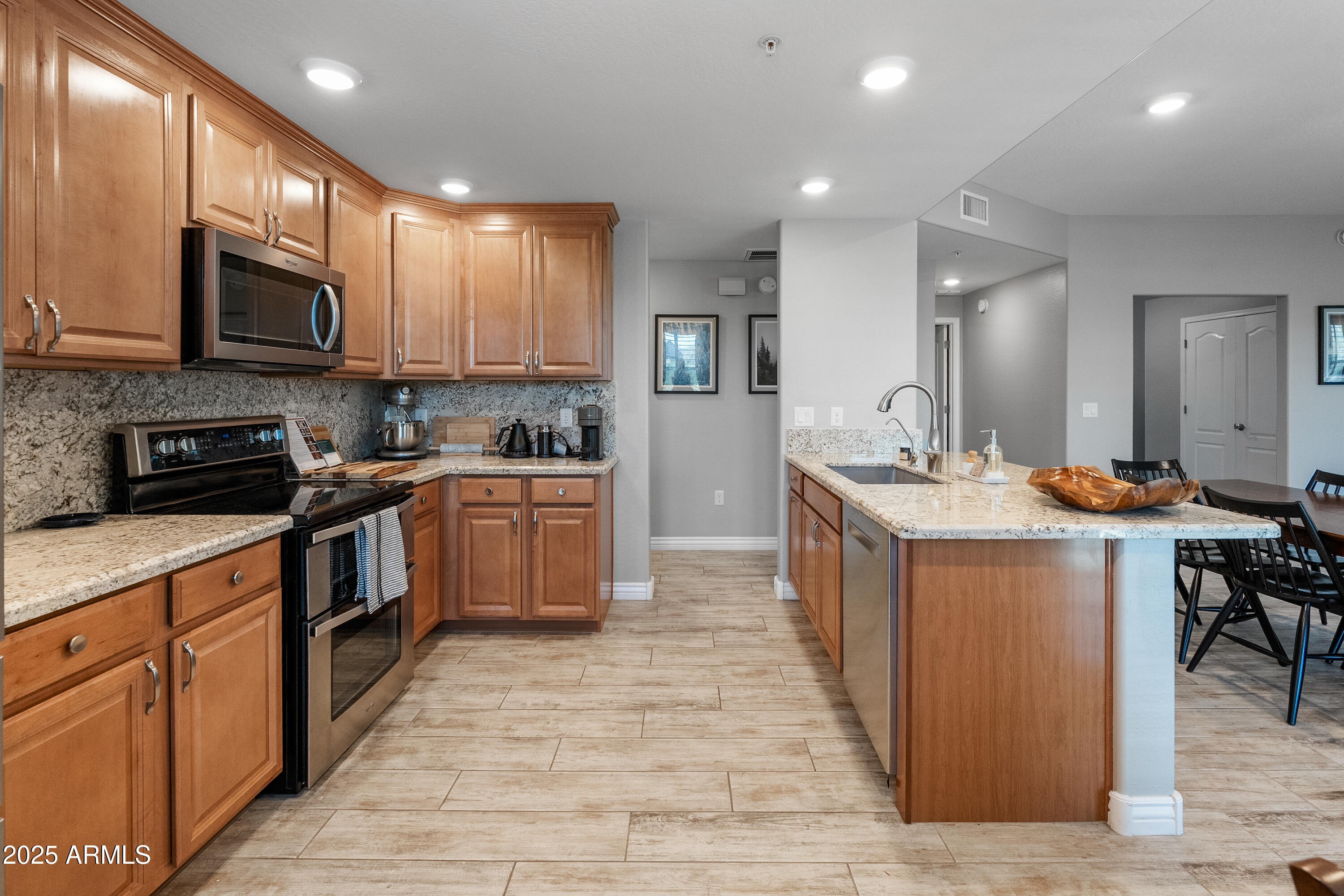 2425 West Bronco Butte Trail, Unit 1014 Phoenix, AZ 85085 - Photo 11 of 23 a large kitchen with stainless steel appliances