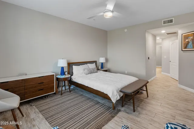 a bedroom with a bed and wooden floor