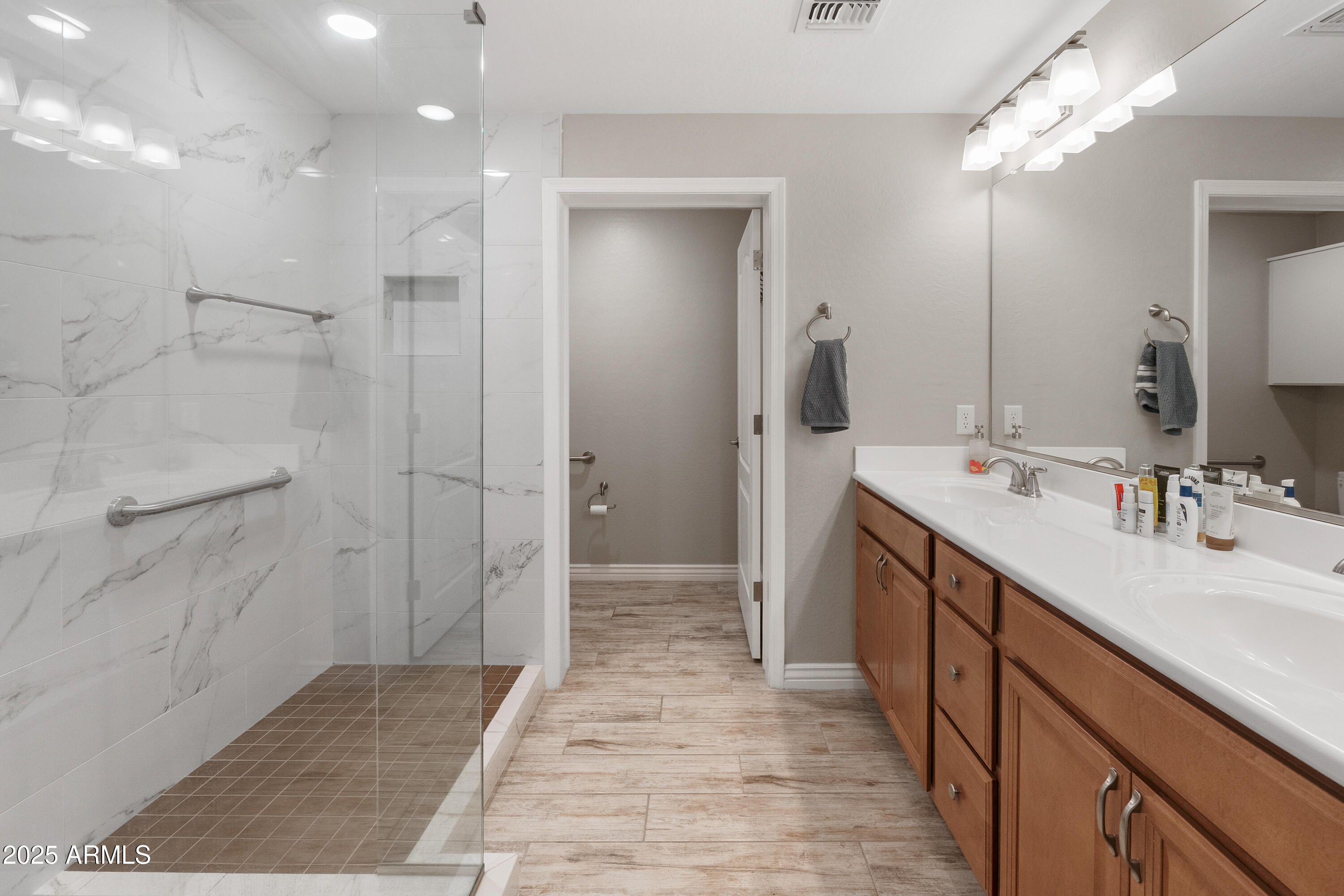 2425 West Bronco Butte Trail, Unit 1014 Phoenix, AZ 85085 - Photo 15 of 23 a bathroom with a sink a shower and a mirror