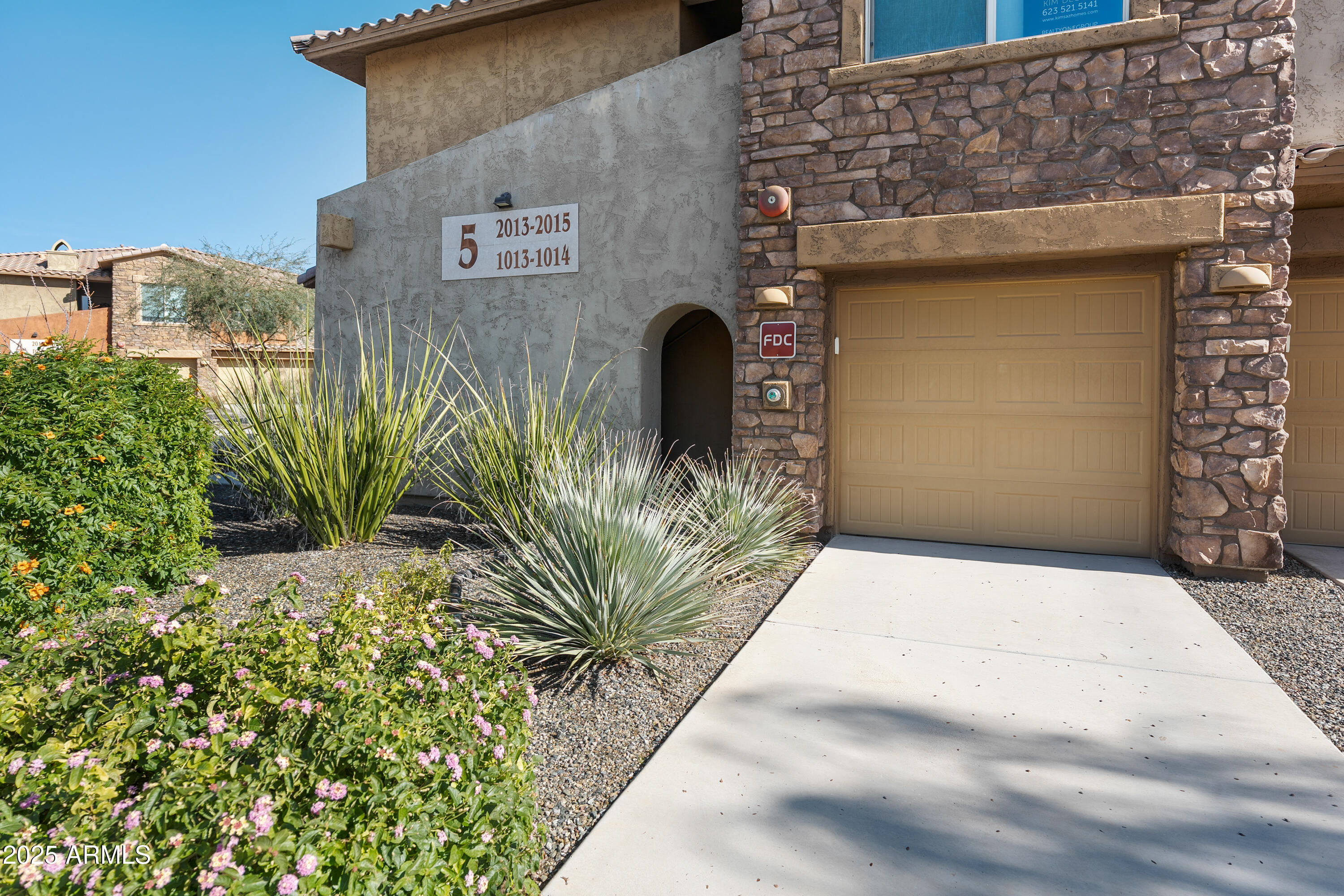 2425 West Bronco Butte Trail, Unit 1014 Phoenix, AZ 85085 - Photo 21 of 23 a front view of a house with garden