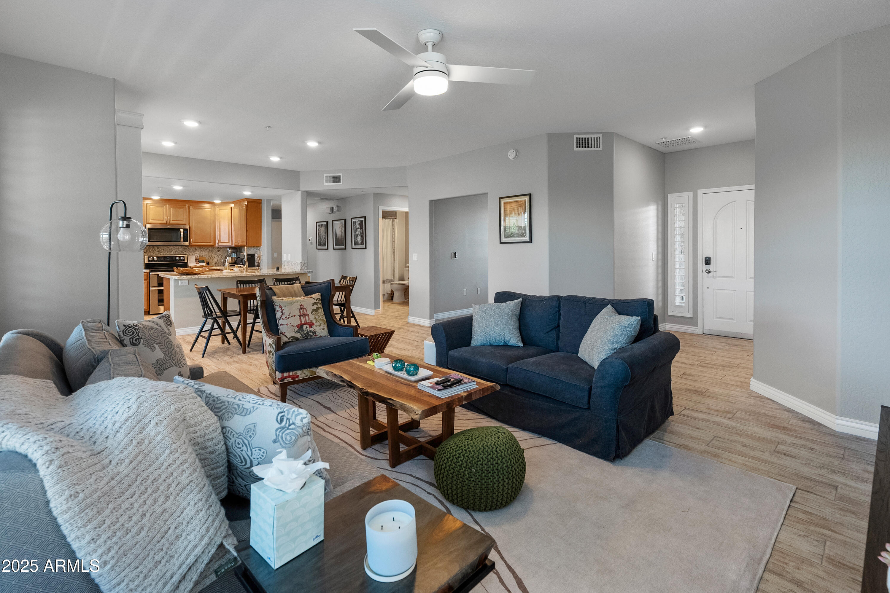 2425 West Bronco Butte Trail, Unit 1014 Phoenix, AZ 85085 - Photo 3 of 23 a living room with furniture kitchen view and a wooden floor