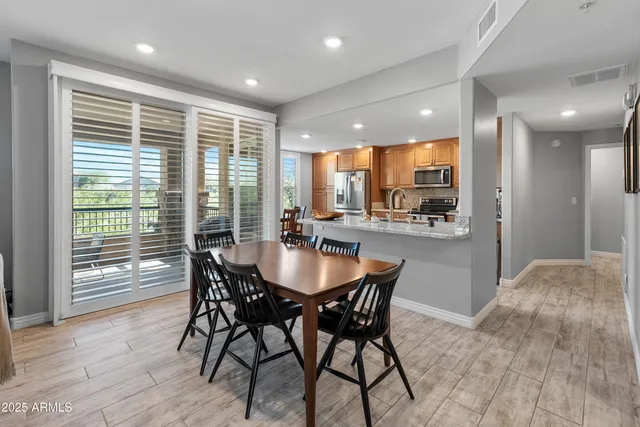 a view of a a dining room with furniture window and wooden floor