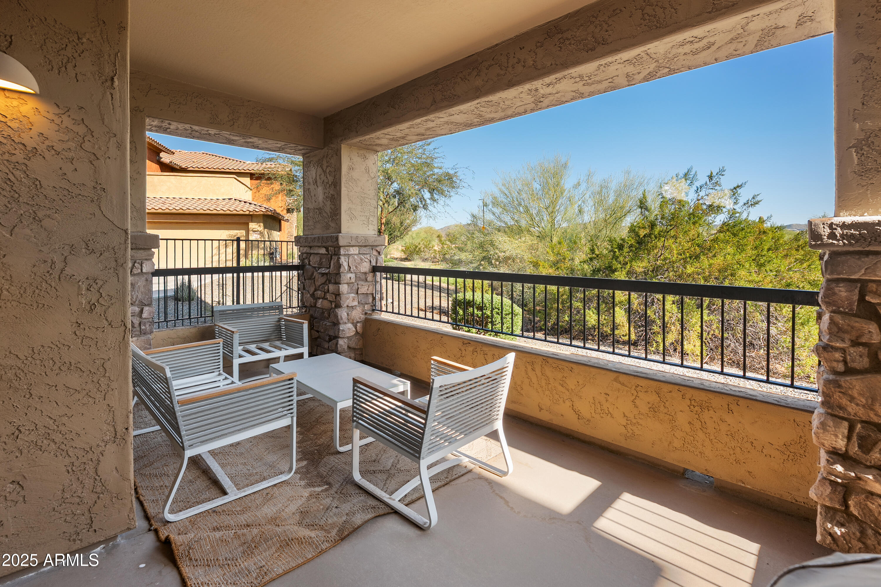 2425 West Bronco Butte Trail, Unit 1014 Phoenix, AZ 85085 - Photo 5 of 23 a view of a balcony with chairs
