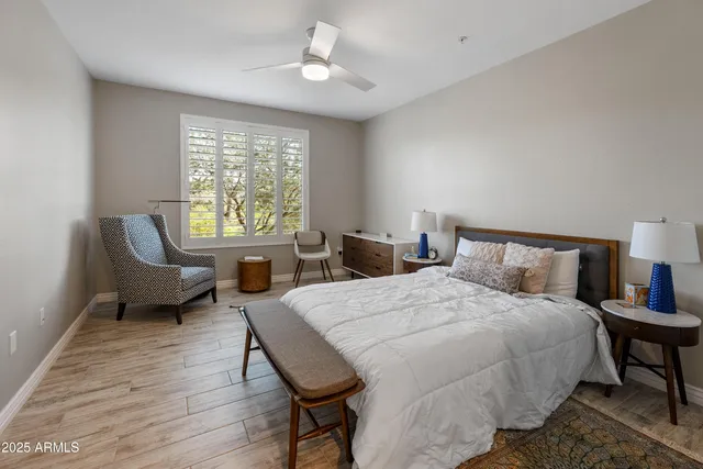 a bedroom with a bed and a large window