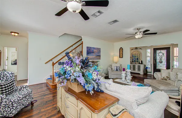 a living room with furniture and a chandelier