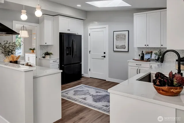 a kitchen with a refrigerator and a sink