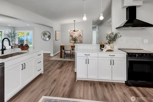 a kitchen with a sink cabinets and wooden floor