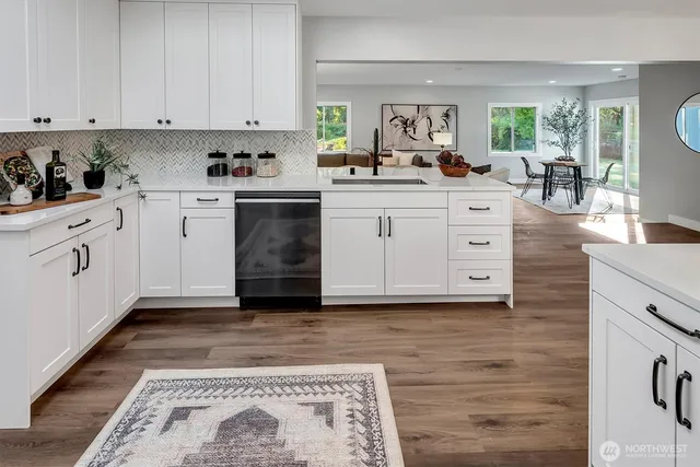 a kitchen with white cabinets and white appliances