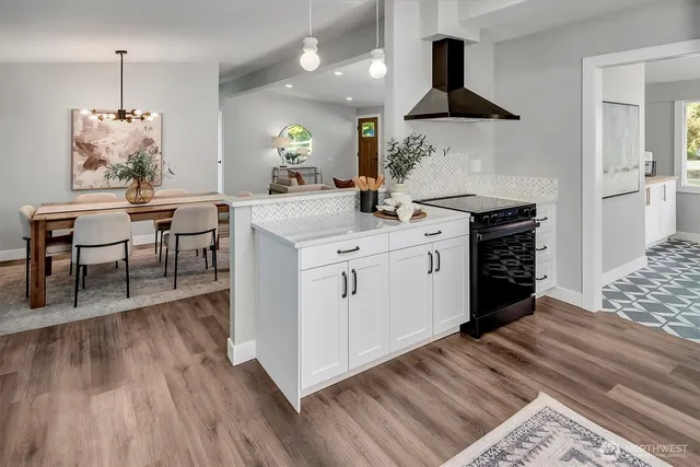 a kitchen with a sink and stove top oven