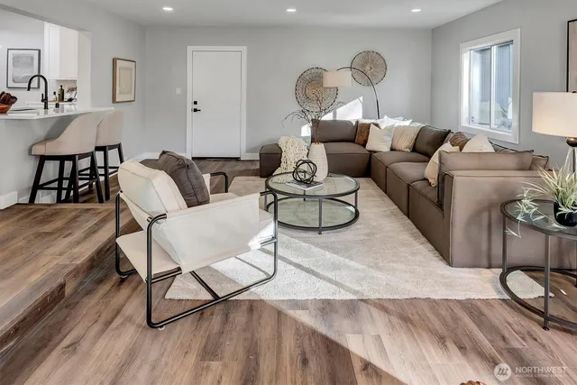a living room with furniture a rug and a chandelier