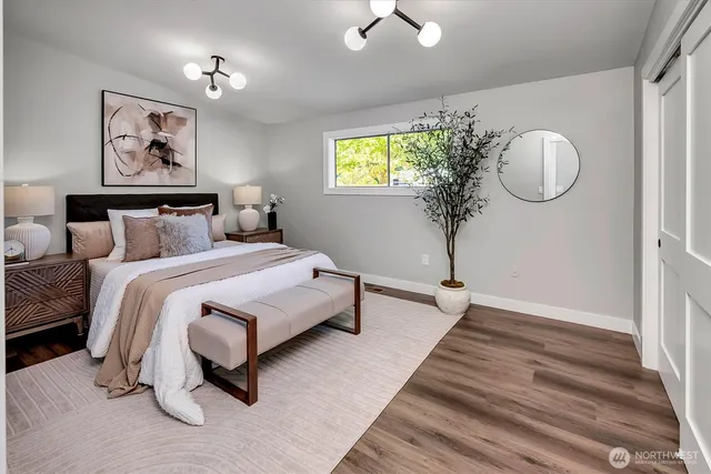 a bedroom with a bed and a chandelier