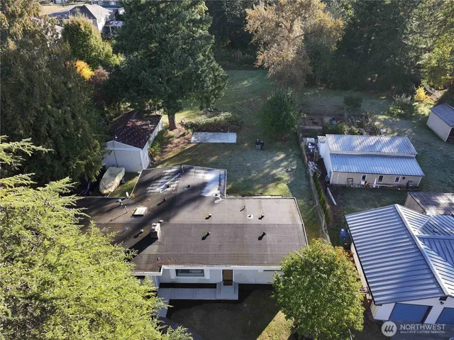 an aerial view of a house with a yard