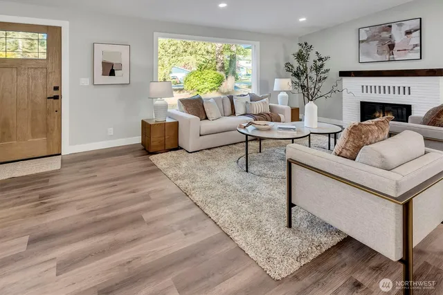 a living room with furniture and a fireplace