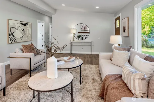 a living room with furniture and a painting on the wall