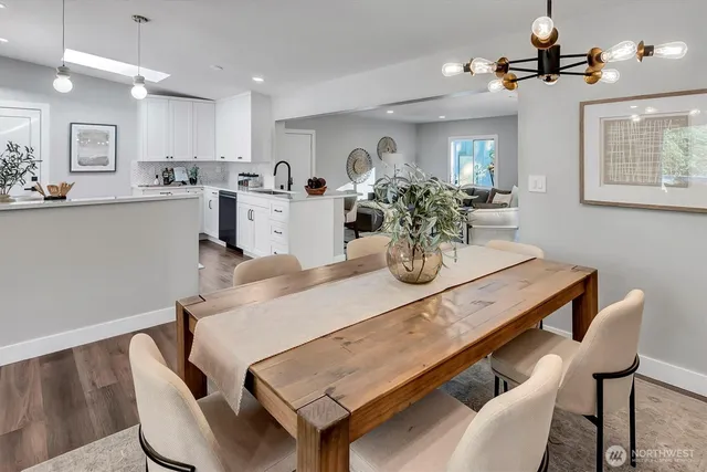 a view of a dining room with furniture and chandelier