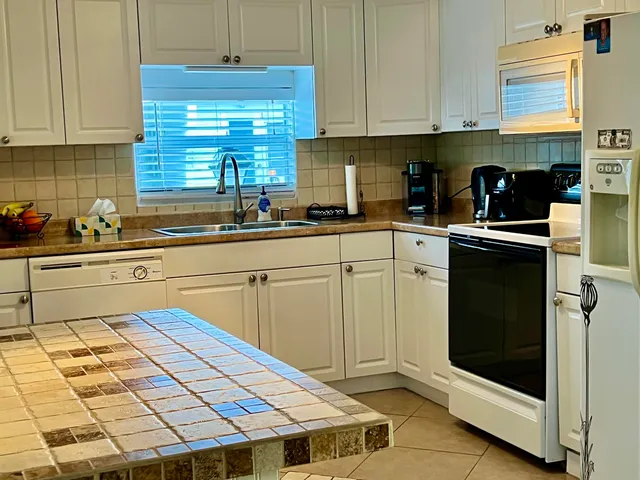 a kitchen with a sink cabinets and window