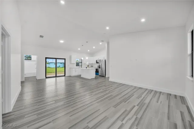 a view of empty room with wooden floor