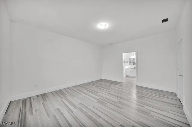 a view of an empty room and wooden floor