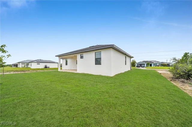 a view of an house with backyard space and garden