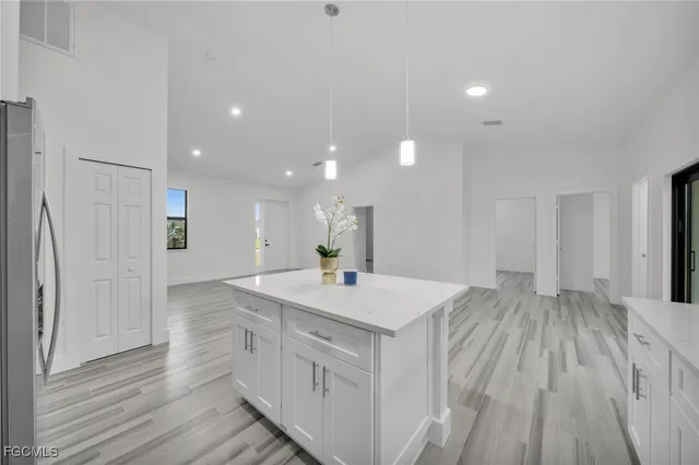 a kitchen with a sink and wooden floor