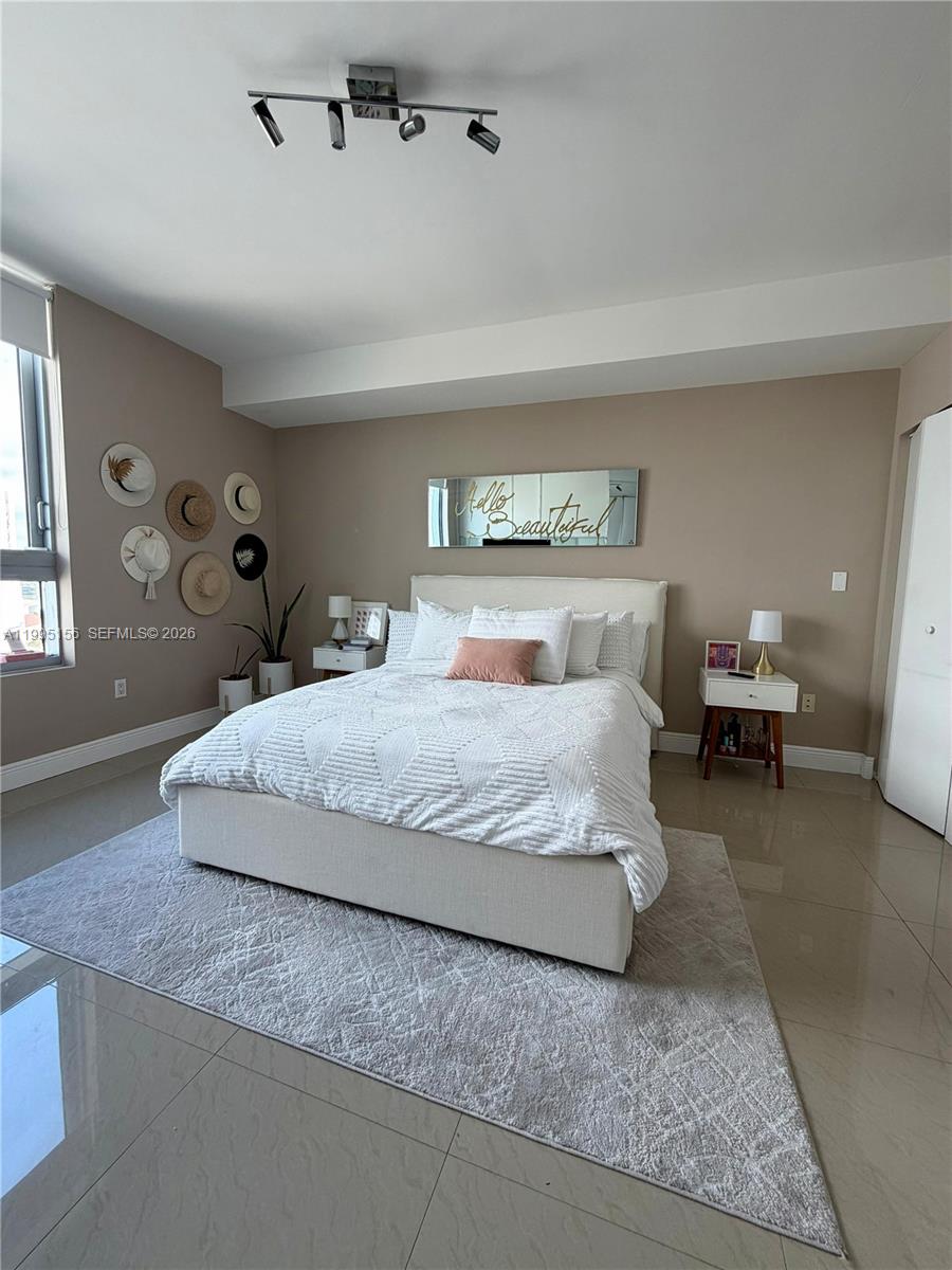 90 Southwest 3rd Street, Unit 2112 Miami, FL 33130 - Photo 11 of 40 a bedroom with a bed and window