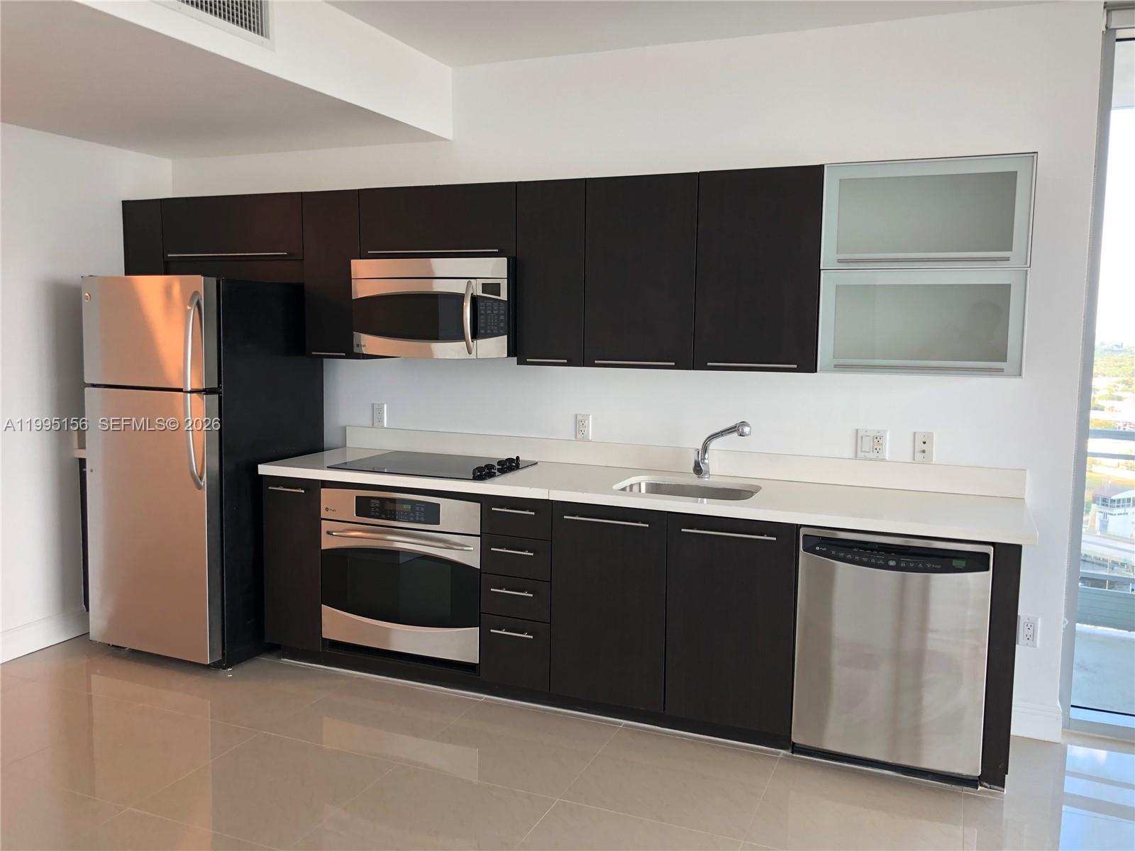 90 Southwest 3rd Street, Unit 2112 Miami, FL 33130 - Photo 17 of 40 a kitchen with a sink and a refrigerator