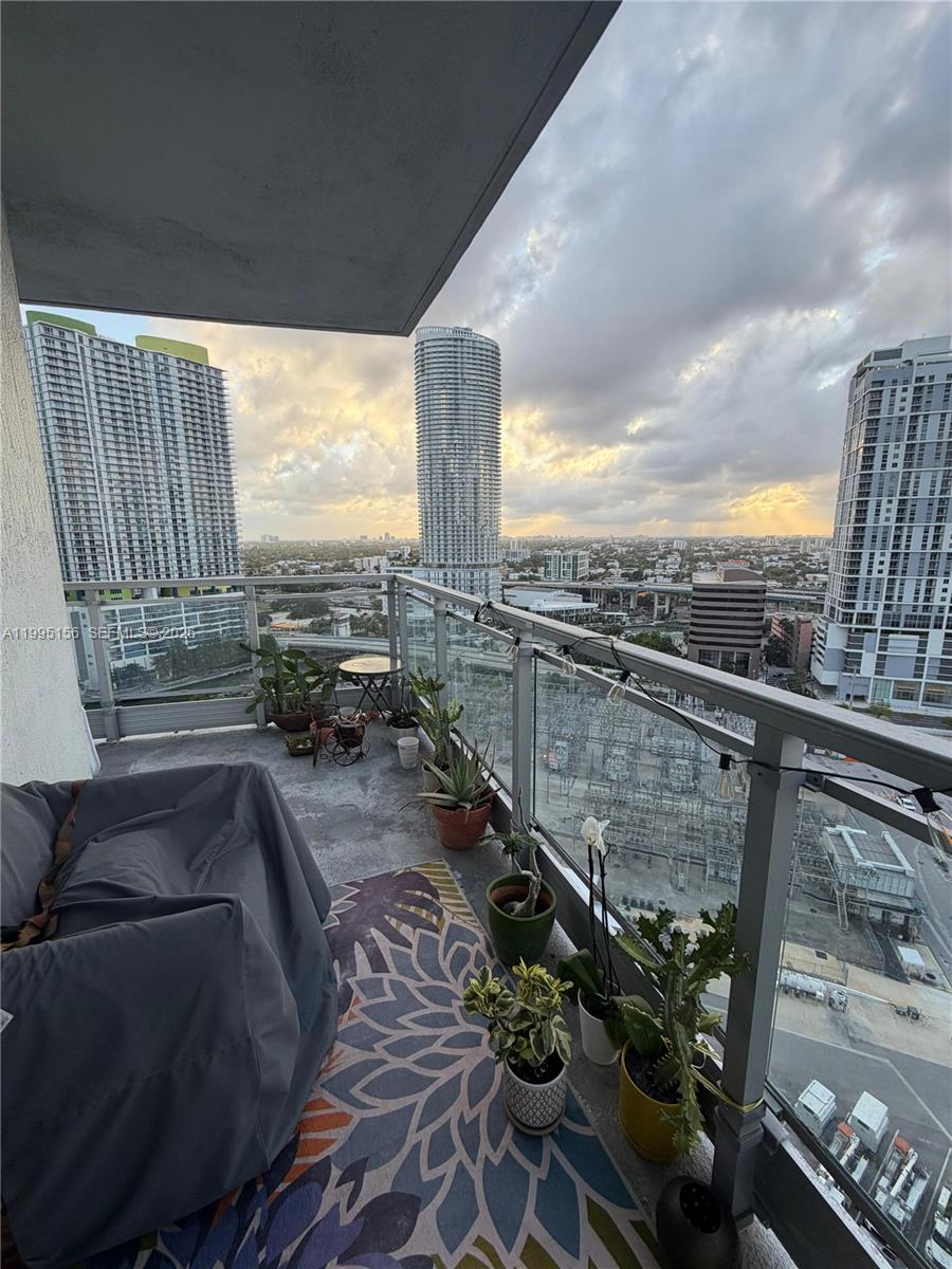 90 Southwest 3rd Street, Unit 2112 Miami, FL 33130 - Photo 2 of 40 a view of balcony with furniture and city view