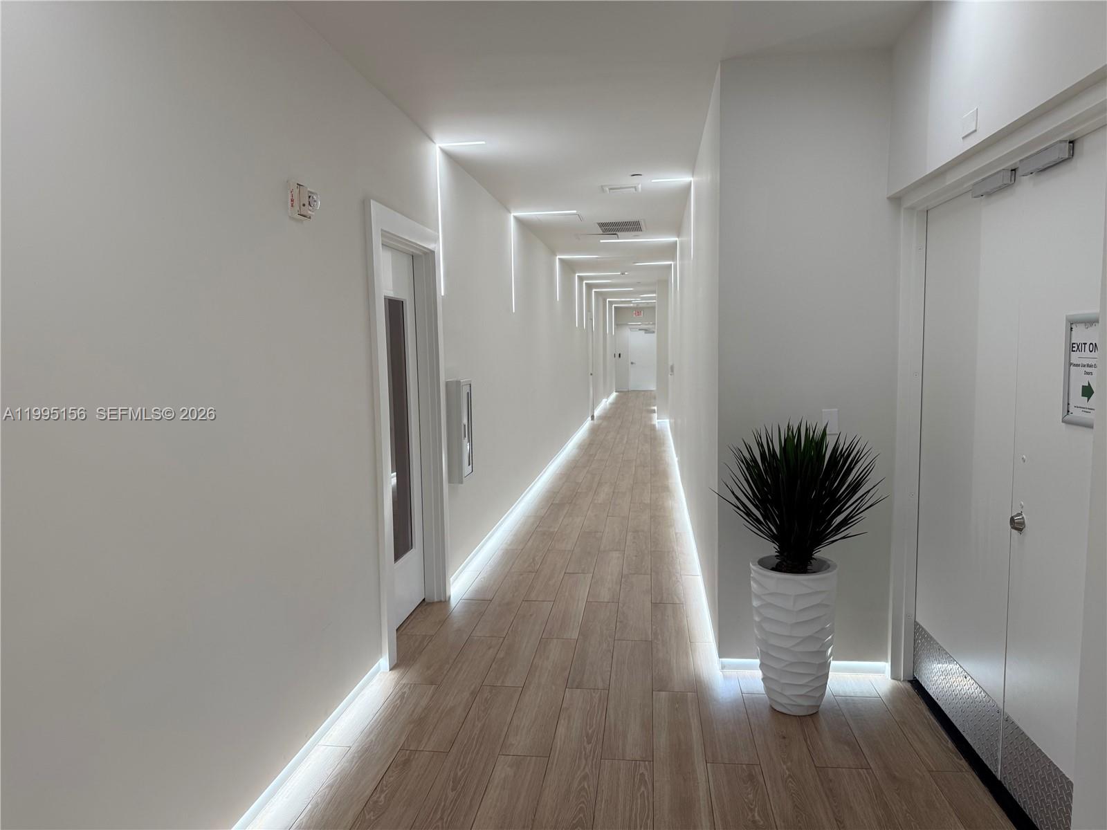 90 Southwest 3rd Street, Unit 2112 Miami, FL 33130 - Photo 26 of 40 a view of a hallway with wooden floor and a living room